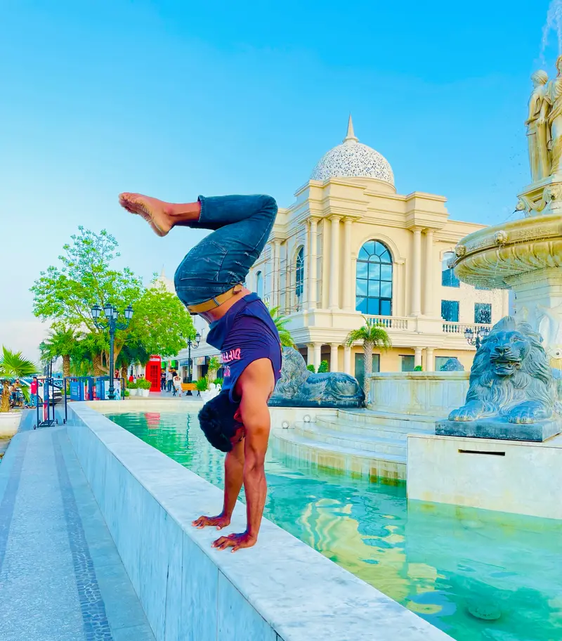 Handstand by a fountain promenade